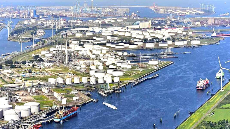 Aerial view of Rotterdam port with industrial storage tanks and waterways