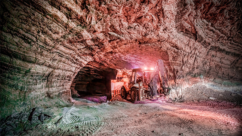 Underground salt cavern with heavy machinery used for large-scale hydrogen storage projects