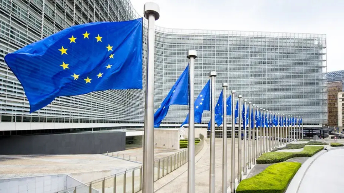 EU flags outside European Commission building representing new hydrogen funding efforts.