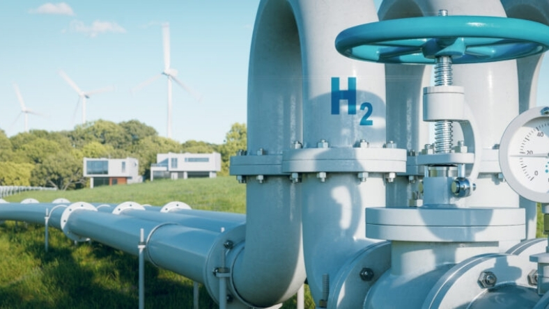 Hydrogen pipeline infrastructure with H2 valve and wind turbines in background