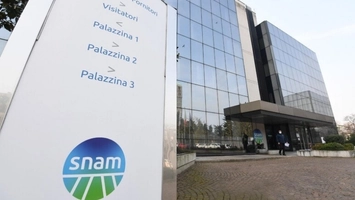 Snam branded entrance sign outside corporate glass headquarters